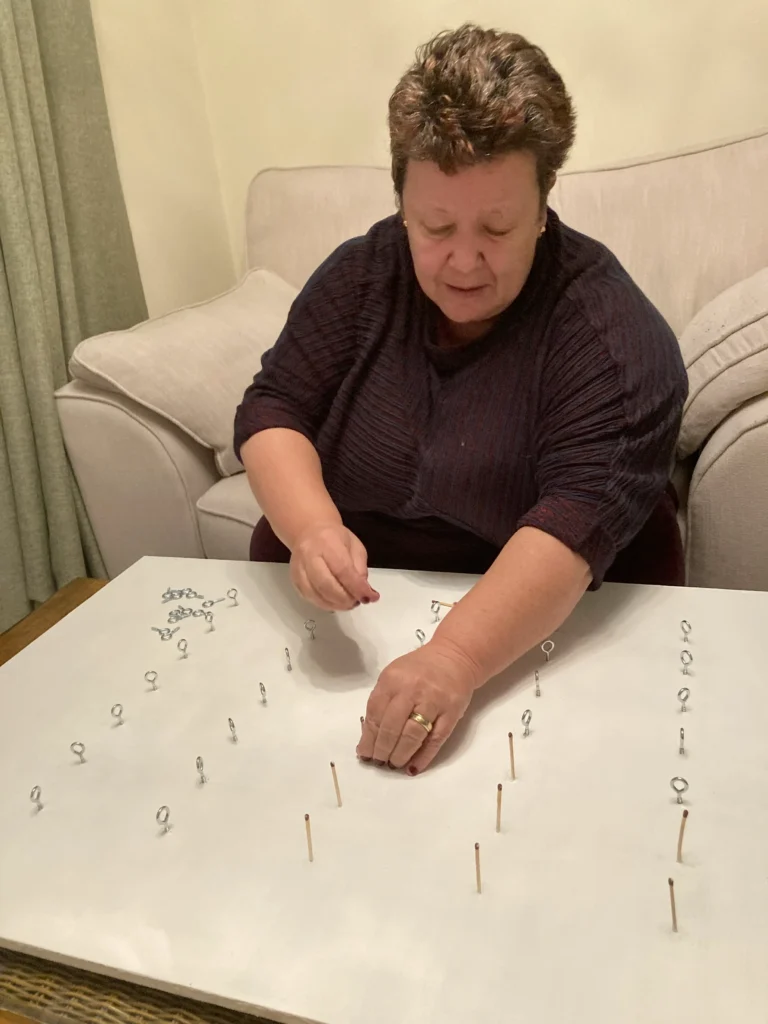 Judy putting together the artwork piece for rising tides.